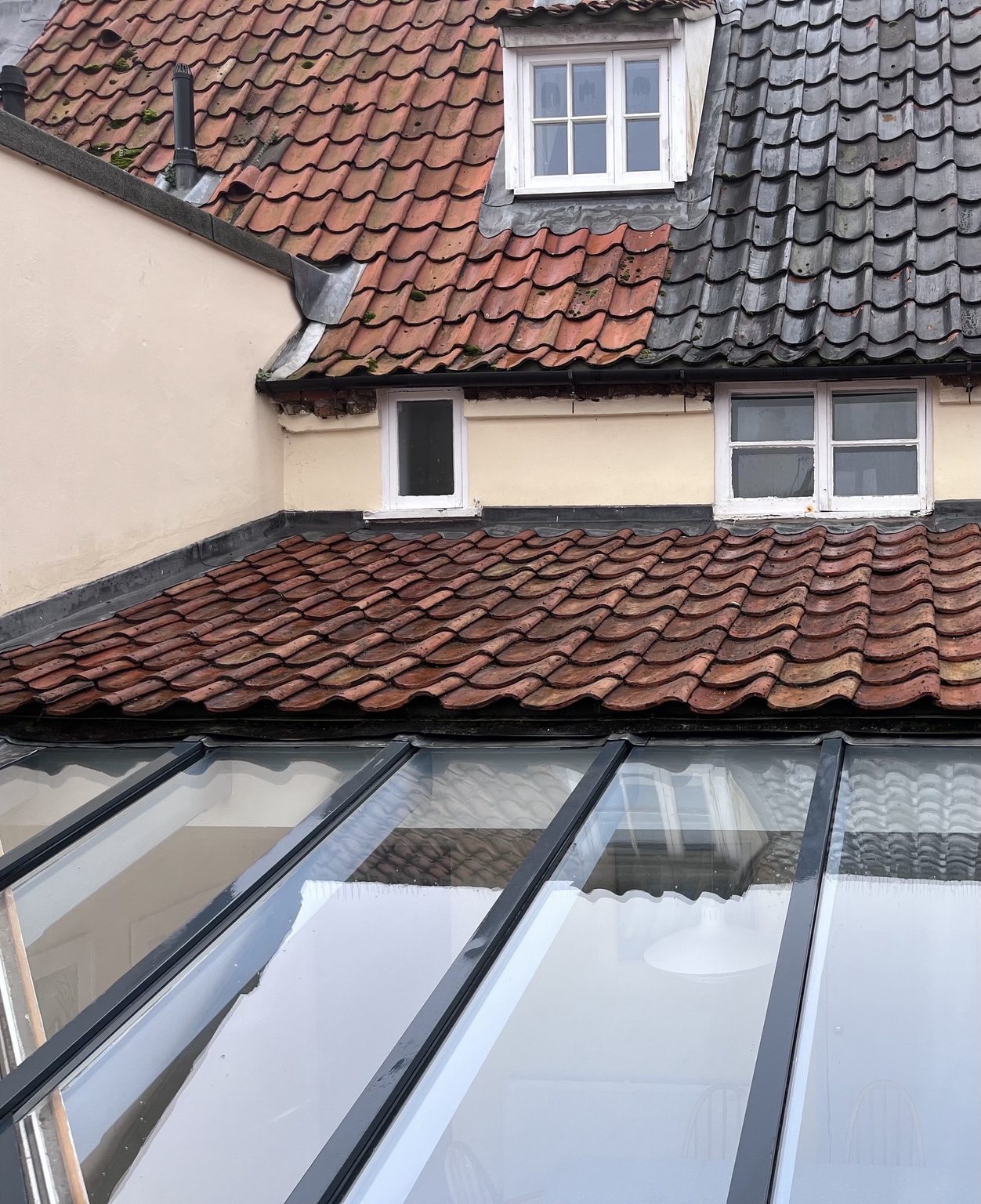 Lower tiled roof after moss removal, with the glass canopy cleaned